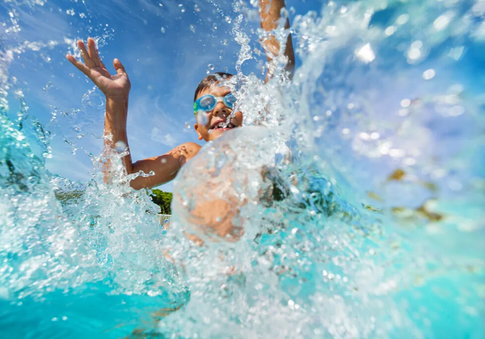 Child splashing into a pool